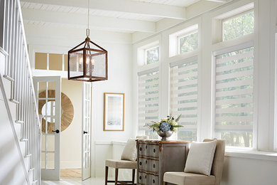 Example of a large cottage painted wood floor entryway design in New York with white walls and a white front door