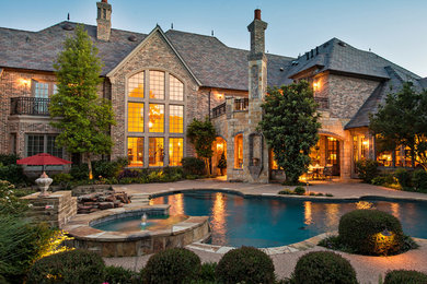 Inspiration for a large craftsman two-story stone house exterior remodel in Dallas