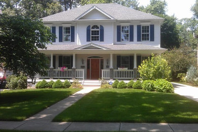 Example of a large classic white two-story vinyl exterior home design in Chicago with a hip roof