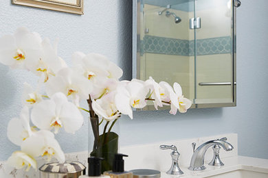 Alcove shower - traditional white tile and ceramic tile marble floor alcove shower idea in San Francisco with shaker cabinets, white cabinets, blue walls, an undermount sink and quartz countertops