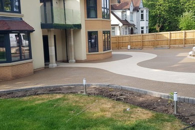 Photo of a medium sized modern front driveway garden in Cardiff with natural stone paving.