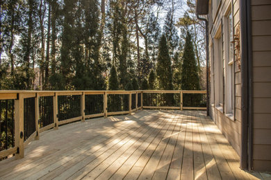 Example of a backyard second story wood railing deck design in Atlanta