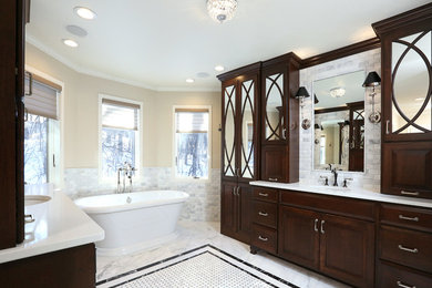 Expansive traditional master bathroom in Other with dark wood cabinets, a freestanding tub and gray tile.