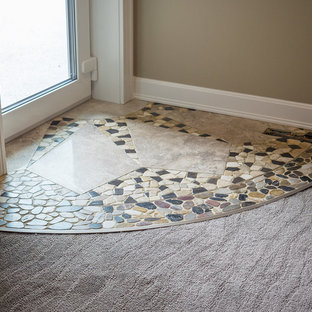 Large traditional walk-out basement in Edmonton with beige walls, marble flooring and multi-coloured floors.