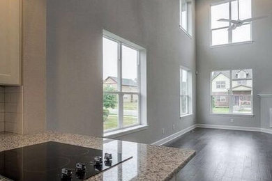 Inspiration for a large modern formal and open concept painted wood floor and gray floor living room remodel in Kansas City with gray walls