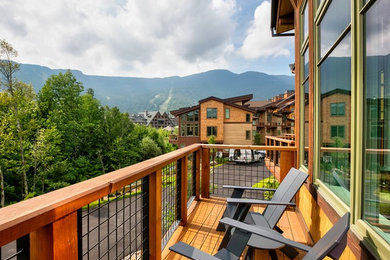 Example of a transitional mixed material railing balcony design in Burlington with no cover