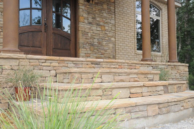 Mid-sized craftsman beige one-story stone exterior home idea in Nashville with a shingle roof