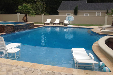 Inspiration for a large timeless backyard concrete paver and rectangular lap hot tub remodel in Other
