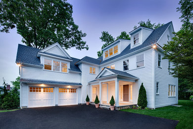 Example of a large transitional white three-story wood house exterior design in Other with a clipped gable roof