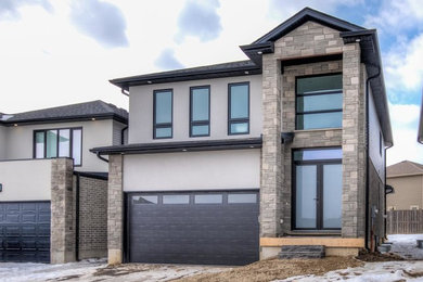 Mid-sized transitional gray two-story brick house exterior idea in Toronto with a shingle roof