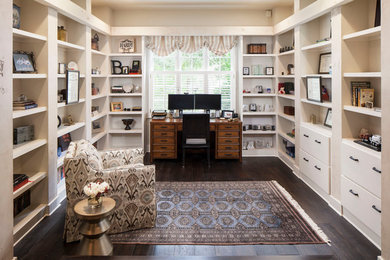 Elegant dark wood floor home office photo in Austin with beige walls