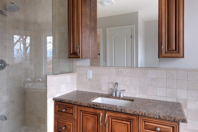 Bathroom - beige tile marble floor bathroom idea in Toronto with dark wood cabinets, granite countertops and white walls