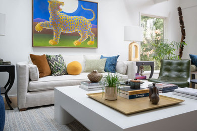 Inspiration for an eclectic medium tone wood floor and brown floor living room remodel in Baltimore with white walls