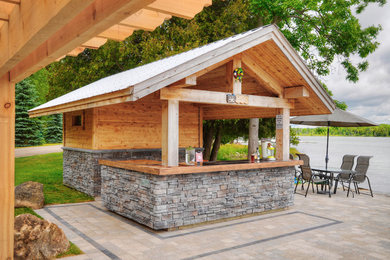 Photo of a traditional patio in Toronto with a gazebo/cabana and concrete pavers.