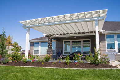 Example of a minimalist backyard patio design in Boise with a pergola
