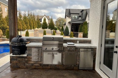 Outdoor kitchen/ fireplace and pool landscaping