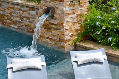 Inspiration for a contemporary backyard rectangular lap pool in Houston with a water feature.