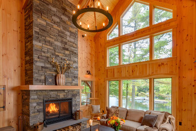 Large mountain style open concept and formal light wood floor and beige floor living room photo in Boston with a ribbon fireplace, a stone fireplace, brown walls and no tv