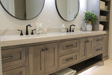 Example of a minimalist master porcelain tile, white floor and double-sink bathroom design in Other with recessed-panel cabinets, light wood cabinets, a drop-in sink, quartz countertops, white countertops and a floating vanity