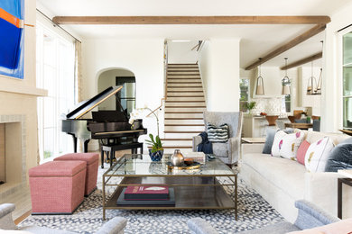 Transitional open concept medium tone wood floor and brown floor living room photo in Dallas with white walls, a standard fireplace and a tile fireplace