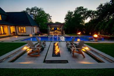 Large traditional back custom shaped lengths swimming pool in Dallas with tiled flooring.