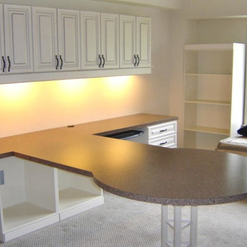 Traditonal office with round extended table and lots of cabinet space