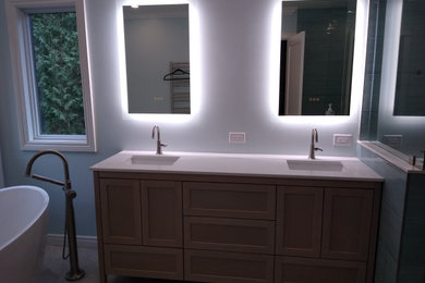 Mid-sized trendy master blue tile and porcelain tile porcelain tile, beige floor and double-sink bathroom photo in Toronto with shaker cabinets, light wood cabinets, a one-piece toilet, blue walls, an undermount sink, quartz countertops, white countertops, a niche and a freestanding vanity