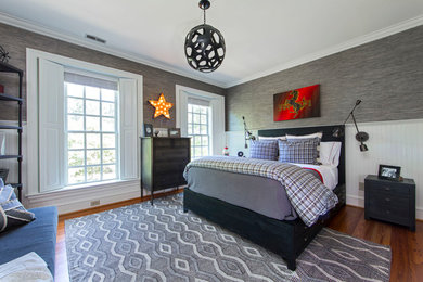 Large modern bedroom in Charlotte with grey walls, medium hardwood floors and no fireplace.