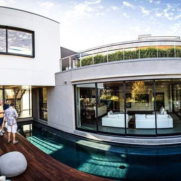 Contemporary lap pool alongside contemporary house