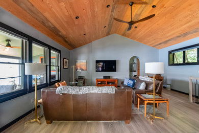 Inspiration for a large modern vinyl floor, gray floor and wood ceiling family room remodel in New York with gray walls, no fireplace and a wall-mounted tv