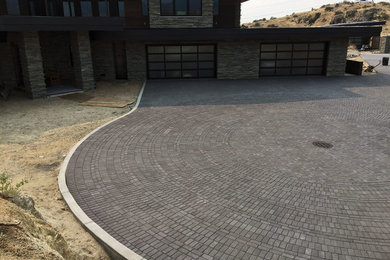 Inspiration for a huge contemporary full sun front yard brick driveway in Boise.