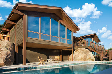 Example of a large trendy brown two-story wood exterior home design in Santa Barbara with a hip roof