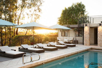 Pool - large contemporary backyard stone and rectangular lap pool idea in San Diego