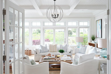 Large beach style living room photo in Boston with white walls