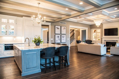 Inspiration for a transitional l-shaped dark wood floor and brown floor open concept kitchen remodel in Cincinnati with an undermount sink, raised-panel cabinets, white cabinets, white backsplash, subway tile backsplash, paneled appliances, an island and white countertops