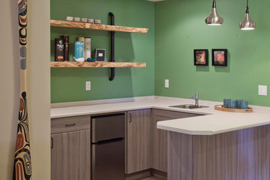 This is an example of a small contemporary wet bar in Vancouver with a drop-in sink, flat-panel cabinets, light wood cabinets, green splashback and ceramic floors.