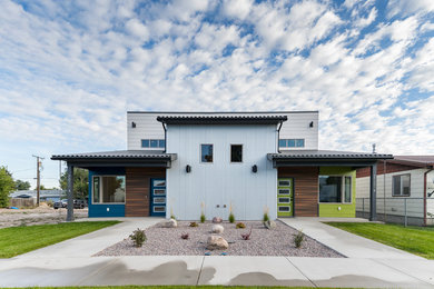 Mid-sized trendy two-story concrete exterior home photo in Other