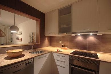 Photo of a mid-sized contemporary l-shaped open plan kitchen in Other with a single-bowl sink, flat-panel cabinets, white cabinets, stainless steel appliances and no island.