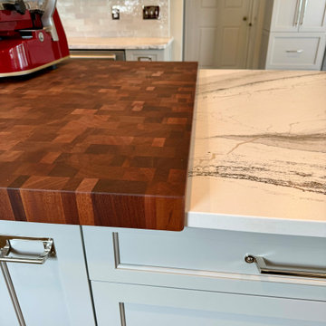 Thick sapele mahogany wood top overlapping the quartz counter