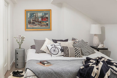 This is an example of a mid-sized contemporary guest bedroom in Boston with grey walls and light hardwood floors.