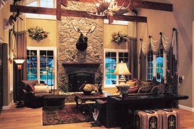 Inspiration for a large country open concept living room in Cincinnati with beige walls, light hardwood floors, a standard fireplace, a stone fireplace surround and no tv.