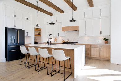 Danish l-shaped kitchen photo in Other with shaker cabinets and an island