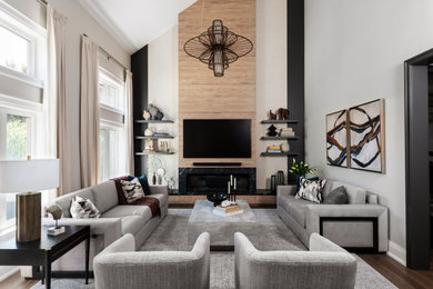 Example of a mid-sized transitional enclosed dark wood floor, brown floor and coffered ceiling living room design in Toronto with white walls, a standard fireplace, a tile fireplace and a wall-mounted tv