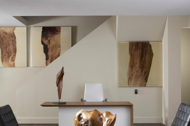 Study room - large modern freestanding desk dark wood floor study room idea in San Diego with white walls