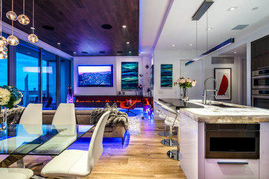 Huge trendy formal and open concept living room photo in Tampa with white walls, a corner fireplace and a wall-mounted tv