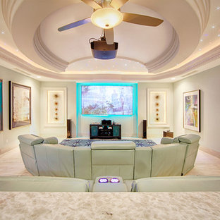 This is an example of a large classic home cinema in Mexico City with light hardwood flooring and a projector screen.