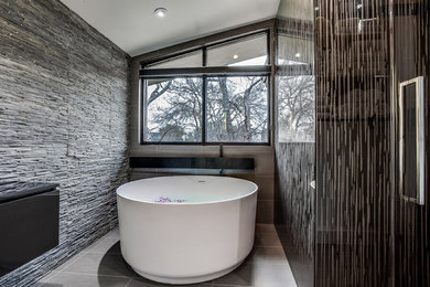 This is an example of a large contemporary master bathroom in Dallas with a freestanding tub, gray tile, stone tile, grey walls, ceramic floors, grey floor, flat-panel cabinets, black cabinets, an alcove shower, a pedestal sink, solid surface benchtops and an open shower.