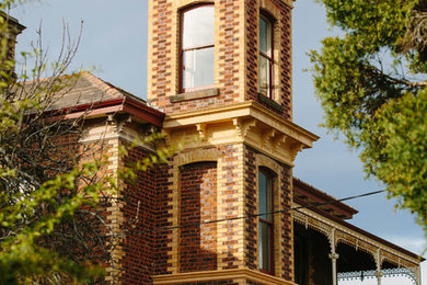 Inspiration for a large traditional two-storey brick brown exterior in Melbourne with a gable roof.