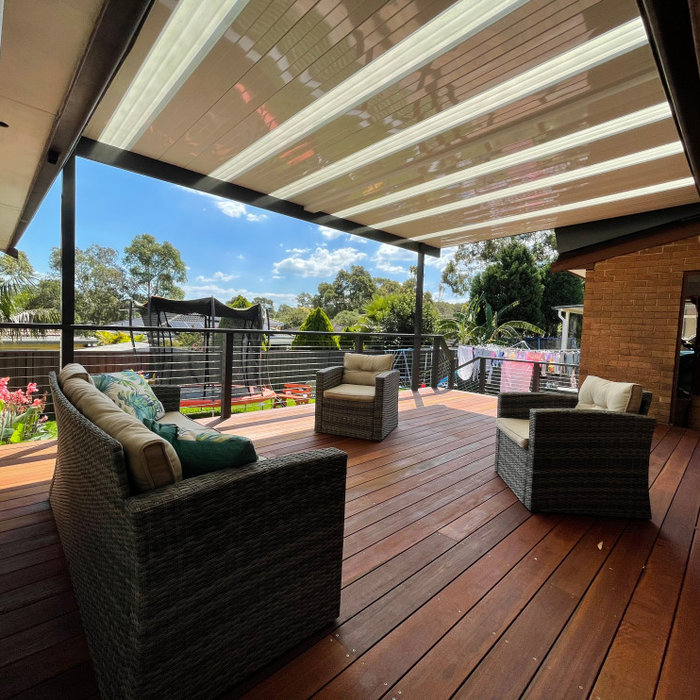 Inspiration for a large modern backyard and ground level deck in Sydney with a pergola.