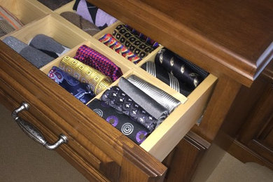 Dressing room - mid-sized traditional men's carpeted dressing room idea in Cleveland with raised-panel cabinets and medium tone wood cabinets